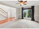 Bright living room features plush carpet, natural light, and a ceiling fan for added comfort at 2437 Camden Lake Nw Vw, Acworth, GA 30101