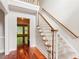 Elegant staircase with hardwood floors and white railings leading to the upper level at 2437 Camden Lake Nw Vw, Acworth, GA 30101
