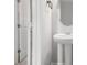Pedestal sink and round mirror in a stylish, neutral-toned powder room at 458 Ajo Way, Dallas, GA 30157