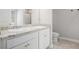 Bathroom featuring double sinks with granite countertops, white cabinets, and tile flooring at 458 Ajo Way, Dallas, GA 30157