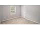 Clean bedroom featuring carpeted flooring, a window and white trim at 458 Ajo Way, Dallas, GA 30157