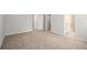 Large, carpeted bedroom with neutral tones, multiple doorways and natural light at 458 Ajo Way, Dallas, GA 30157