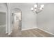 Dining room with modern chandelier lighting with view to open-concept kitchen at 458 Ajo Way, Dallas, GA 30157