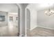 Open-concept dining room with an elegant chandelier, archway access, and light wood floors at 458 Ajo Way, Dallas, GA 30157