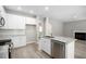 Bright kitchen with white cabinetry, granite countertops, stainless steel appliances, and an island at 458 Ajo Way, Dallas, GA 30157