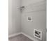 A functional laundry area featuring connections and ample storage on an overhead shelf at 458 Ajo Way, Dallas, GA 30157