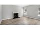 Bright living room featuring stylish wood floors and a cozy fireplace at 458 Ajo Way, Dallas, GA 30157