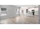 Bright and open living space with a view of the kitchen, light wood flooring, and neutral walls at 458 Ajo Way, Dallas, GA 30157
