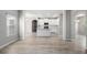 Open-concept living space with gray walls, wood floors, white kitchen cabinets and stainless appliances at 458 Ajo Way, Dallas, GA 30157