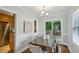 An open dining room showcasing hardwood floors, a modern chandelier, and a view of the backyard through sliding doors at 1100 Faith Se Ave, Atlanta, GA 30316