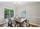 Well-lit dining area with a wood table, comfortable seating, and access to the outdoor living space at 1100 Faith Se Ave, Atlanta, GA 30316