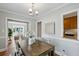 Charming dining room with hardwood floors, modern lighting, and a view of the living room and kitchen at 1100 Faith Se Ave, Atlanta, GA 30316