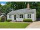 Charming single-story home with gray siding, well-manicured lawn, and mature landscaping at 1100 Faith Se Ave, Atlanta, GA 30316