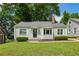 Charming single-story home with a grey exterior, brick chimney, and well-manicured lawn at 1100 Faith Se Ave, Atlanta, GA 30316