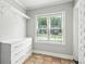 Well-lit laundry room featuring a storage cabinet, hanging rack, and a window at 1100 Faith Se Ave, Atlanta, GA 30316