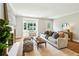 Stylish living room with hardwood floors, fireplace, console table, and view of the front yard at 1100 Faith Se Ave, Atlanta, GA 30316