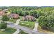 Beautiful home with a circular driveway on a landscaped lot, surrounded by mature trees at 2628 Hollow Pne, Conyers, GA 30094