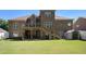 Large backyard with a grassy lawn, two-story house and a back deck at 2628 Hollow Pne, Conyers, GA 30094