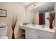 Bright bathroom features a single sink vanity, a toilet, and a large mirror at 2628 Hollow Pne, Conyers, GA 30094