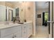 Bathroom with double sink vanity and plenty of storage space. The ensuite bedroom is visible from the door at 2628 Hollow Pne, Conyers, GA 30094
