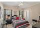 Cozy bedroom features a patterned bedspread, natural light, and neutral tones, creating a comfortable and relaxing space at 2628 Hollow Pne, Conyers, GA 30094