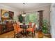Bright breakfast nook features a round glass table, comfortable seating, and plenty of natural light at 2628 Hollow Pne, Conyers, GA 30094