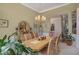 Dining room with an elegant chandelier, wooden table, comfortable seating for six, perfect for Gathering dinners at 2628 Hollow Pne, Conyers, GA 30094