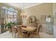 Formal dining room featuring elegant chandelier, large arched window, and seating for six, ideal for Gathering gatherings at 2628 Hollow Pne, Conyers, GA 30094