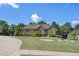 Inviting home with manicured lawn, tasteful landscaping, and a curved driveway at 2628 Hollow Pne, Conyers, GA 30094