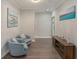 Inviting hallway with wood floors, stylish seating, and decorative wall art at 2628 Hollow Pne, Conyers, GA 30094