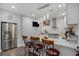 Modern kitchen features stainless steel appliances, granite countertops, and a breakfast bar with seating at 2628 Hollow Pne, Conyers, GA 30094