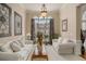 Bright living room featuring large windows, neutral tones, and comfortable seating, creating a relaxing and inviting atmosphere at 2628 Hollow Pne, Conyers, GA 30094