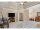 Spacious bedroom with tray ceiling, fan, television, and an adjoining doorway at 2628 Hollow Pne, Conyers, GA 30094