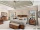 Spacious bedroom suite with tray ceilings, neutral decor, and lots of natural light from dual windows at 2628 Hollow Pne, Conyers, GA 30094