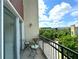 Balcony view with metal railing and a pair of chairs with great views of treelined sidewalks at 390 17Th Nw St # 6001, Atlanta, GA 30363