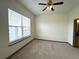 Bright bedroom with carpet, ceiling fan, and large window with natural light at 390 17Th Nw St # 6001, Atlanta, GA 30363