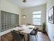 Modern dining room with unique lighting fixture, room for 6, and accent window at 390 17Th Nw St # 6001, Atlanta, GA 30363