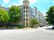 Modern apartment building with colorful exterior, manicured landscaping, and visible scooter rentals at 390 17Th Nw St # 6001, Atlanta, GA 30363