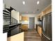 Bright kitchen features stainless steel appliances, black countertops and modern wood cabinets at 390 17Th Nw St # 6001, Atlanta, GA 30363
