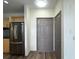 Entrance area near kitchen features a modern refrigerator and pantry door at 390 17Th Nw St # 6001, Atlanta, GA 30363