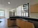 Kitchen with modern wood cabinets and black countertop adjacent to spiral staircase at 390 17Th Nw St # 6001, Atlanta, GA 30363