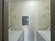 Small laundry room with washer and dryer hookups with wire shelving for storage at 390 17Th Nw St # 6001, Atlanta, GA 30363