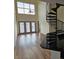 Bright living room with large windows, a spiral staircase, hardwood floors and open to the kitchen at 390 17Th Nw St # 6001, Atlanta, GA 30363