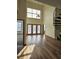 Spacious living room with high ceilings, three large windows, and a spiral staircase at 390 17Th Nw St # 6001, Atlanta, GA 30363