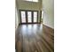 Bright living room with high ceilings, three windows, and wood-look floors at 390 17Th Nw St # 6001, Atlanta, GA 30363
