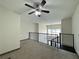 Carpeted loft space features a ceiling fan and railing overlooking the living area at 390 17Th Nw St # 6001, Atlanta, GA 30363
