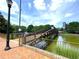 Scenic view of a walkway bridge over a pond, surrounded by lush greenery and landscaping at 390 17Th Nw St # 6001, Atlanta, GA 30363