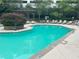 A vibrant community pool featuring crystal clear water, lounge chairs, and a manicured island at 390 17Th Nw St # 6001, Atlanta, GA 30363