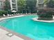 Sparkling community pool with lounge chairs, patio umbrellas, and lush landscaping at 390 17Th Nw St # 6001, Atlanta, GA 30363
