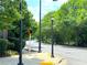 Street corner with mature trees, streetlights, and crosswalk in a walkable neighborhood at 390 17Th Nw St # 6001, Atlanta, GA 30363